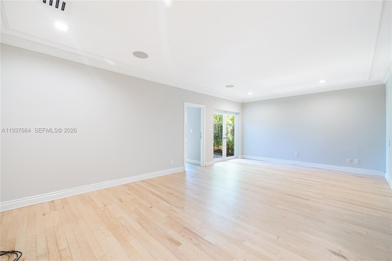 1375 North Biscayne Point Road Miami Beach, FL 33141 - Photo 18 of 40 a view of an empty room with wooden floor and a window