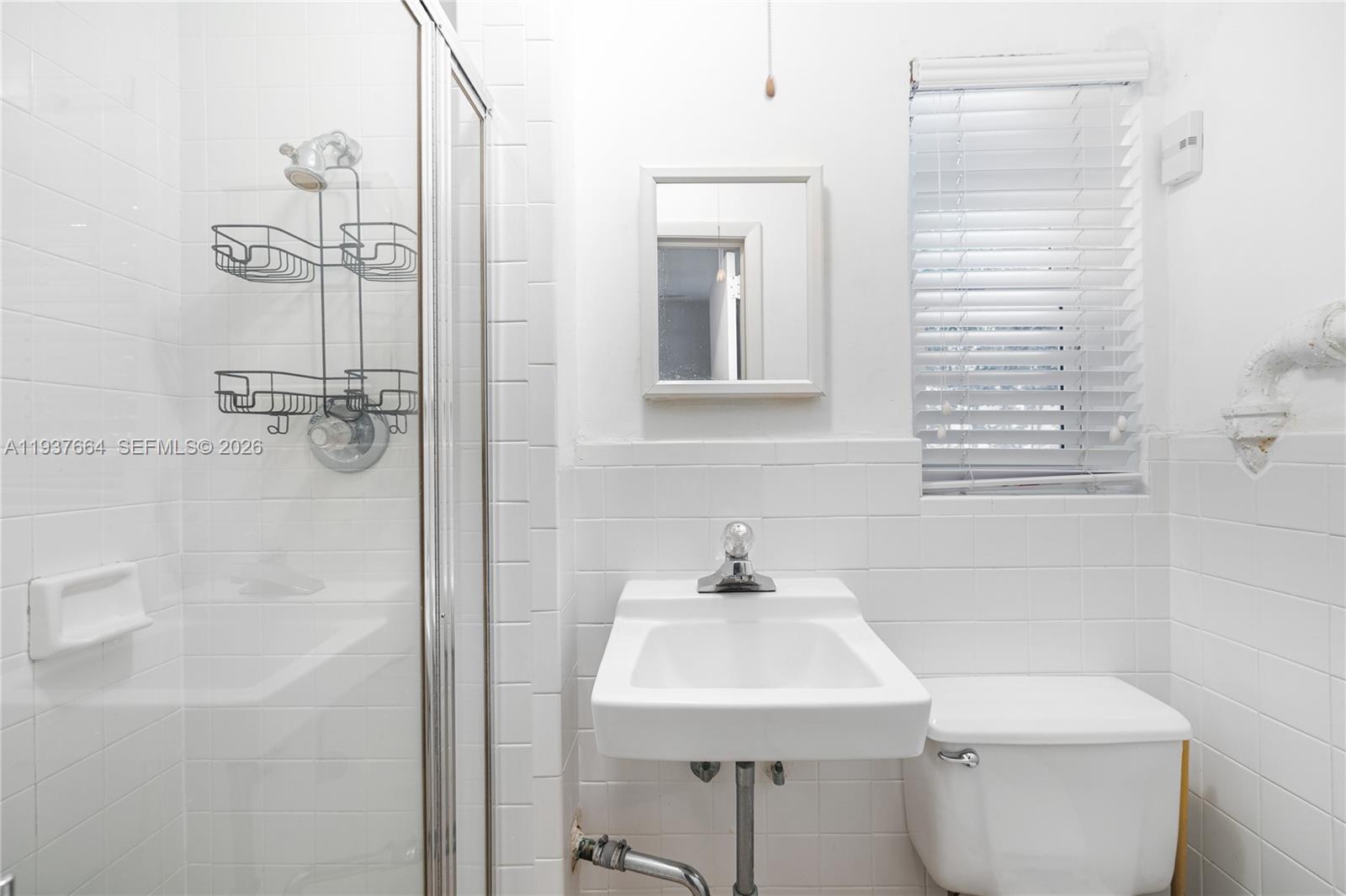 1375 North Biscayne Point Road Miami Beach, FL 33141 - Photo 21 of 40 a bathroom with a sink a toilet and shower