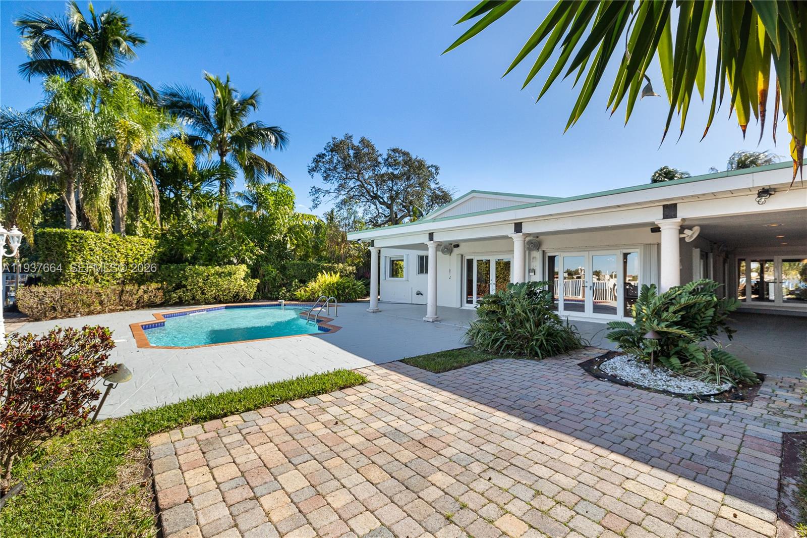 1375 North Biscayne Point Road Miami Beach, FL 33141 - Photo 4 of 40 a front view of a house with a yard and potted plants