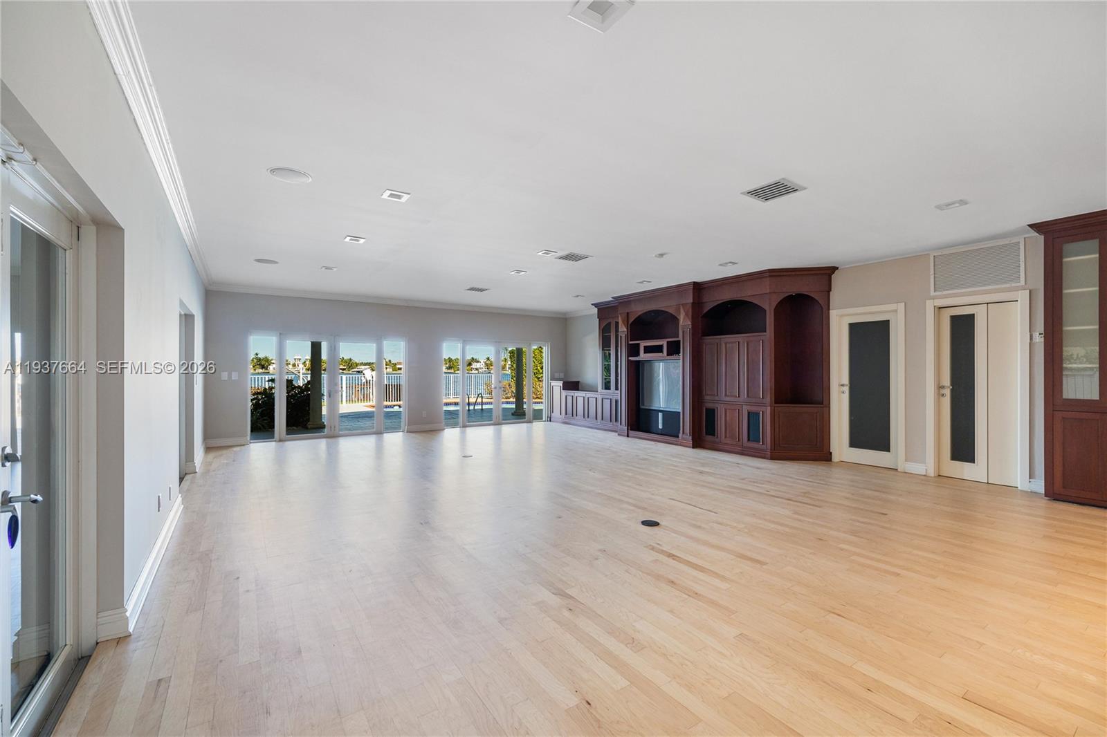 1375 North Biscayne Point Road Miami Beach, FL 33141 - Photo 9 of 40 a view of a big room with wooden floor and windows