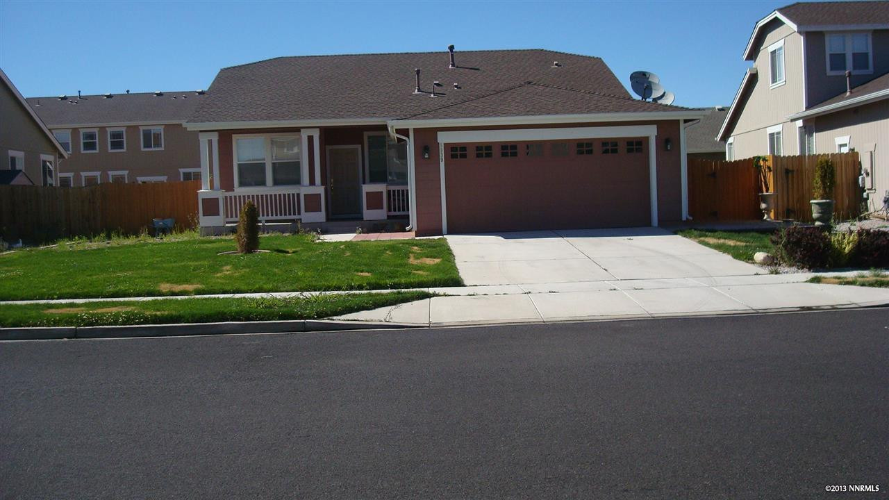 8939 Wynne Street Reno, NV 89506 - Photo 1 of 1 a front view of a house with a yard and garage