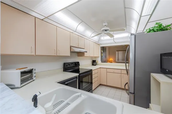 a kitchen with sink cabinets and appliances