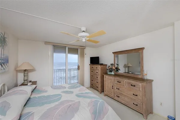 a bedroom with a bed and a dresser in it