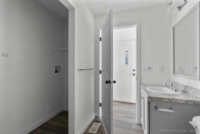 55 Sugar Street, Unit 33 Newtown, CT 06470 - Photo 8 of 17 a bathroom with a granite countertop sink and a mirror