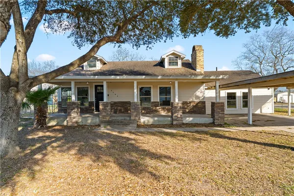 a front view of a house with swimming pool and sitting area