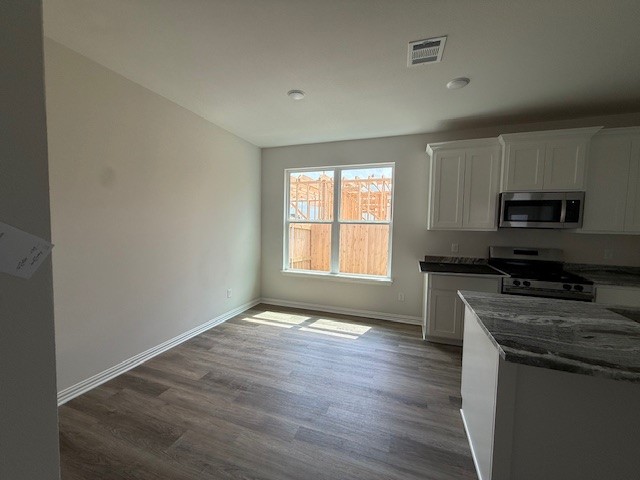 2602 Falcon Ridge Drive Bryan, TX 77803 - Photo 7 of 15 a kitchen with granite countertop wooden floors appliances a sink
