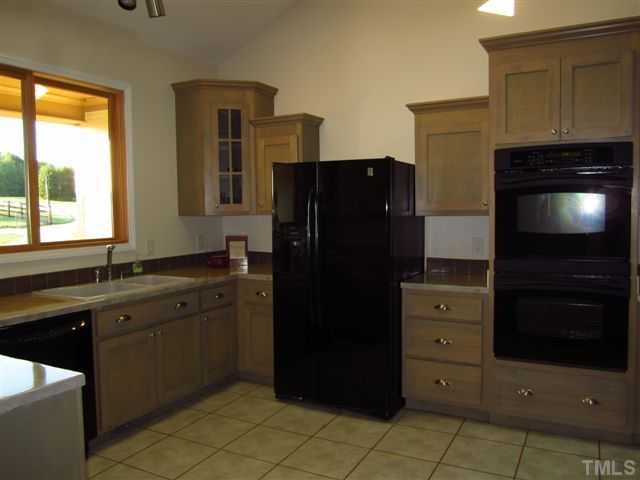 6015 Laws Farm Road Rougemont, NC 27572 - Photo 8 of 25 a kitchen with a refrigerator and a sink