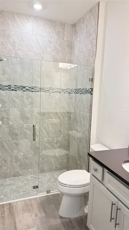 a bathroom with a toilet and a shower