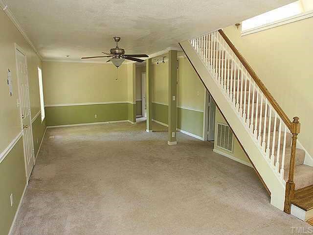 7104 Blalock Road Bahama, NC 27503 - Photo 3 of 8 a view of an empty room with stairs