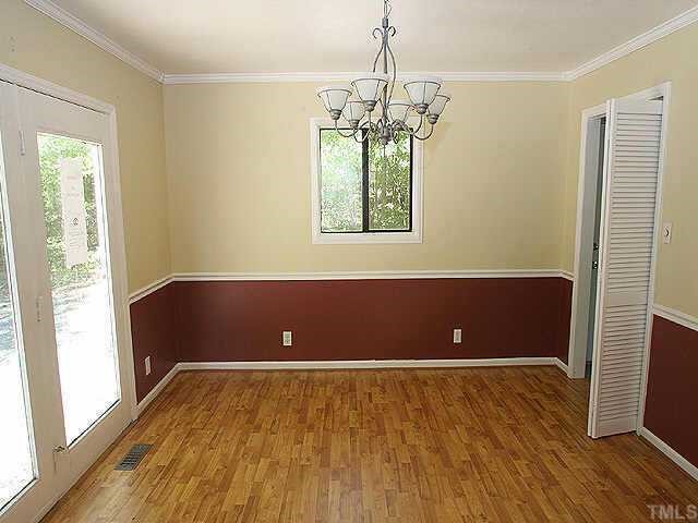 7104 Blalock Road Bahama, NC 27503 - Photo 4 of 8 an empty room with wooden floor and windows