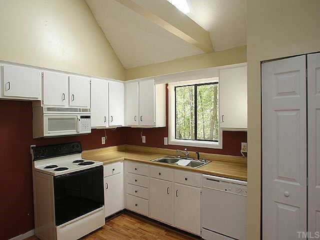 7104 Blalock Road Bahama, NC 27503 - Photo 5 of 8 a kitchen with granite countertop a sink cabinets and stainless steel appliances