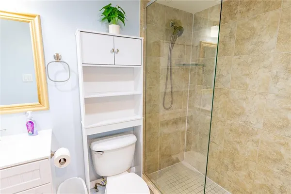 a bathroom with a shower a toilet and a sink