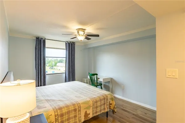 a bedroom with a bed and a chandelier