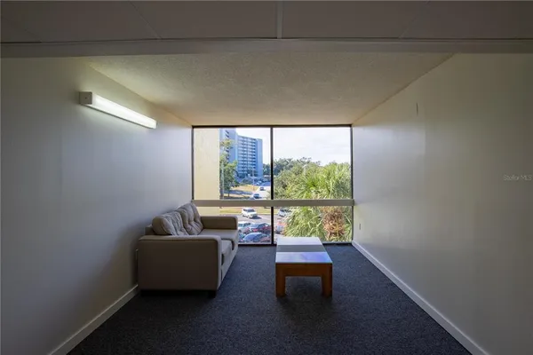 a living room with furniture and a large window