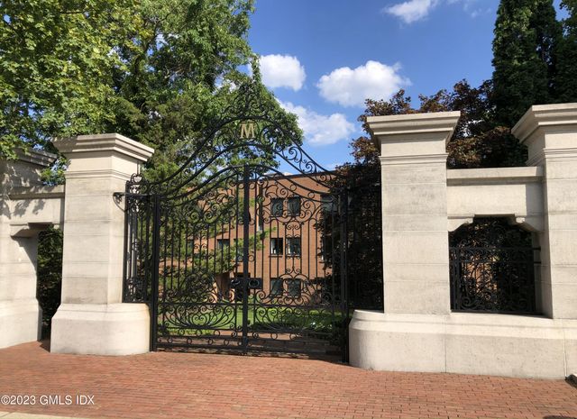 a view of a house with a yard and tree s