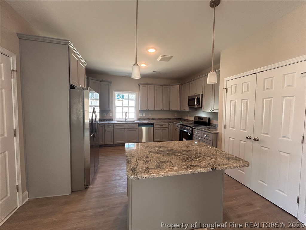 307 Elizabeth Street Spring Lake, NC 28390 - Photo 3 of 12 a kitchen with kitchen island a counter top space stainless steel appliances and cabinets