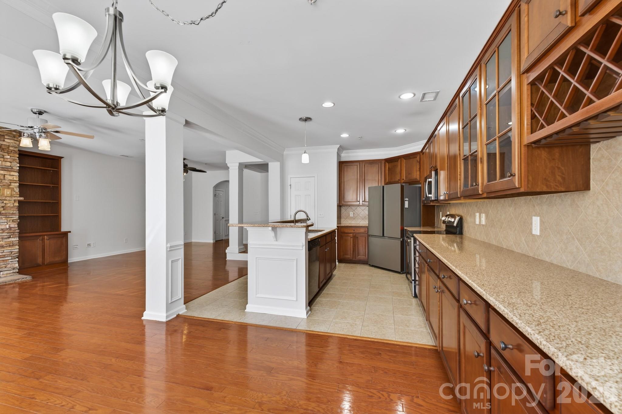 114 Inlet Point Drive Tega Cay, SC 29708 - Photo 11 of 40 a kitchen with stainless steel appliances granite countertop a refrigerator a sink dishwasher a stove and a wooden floors