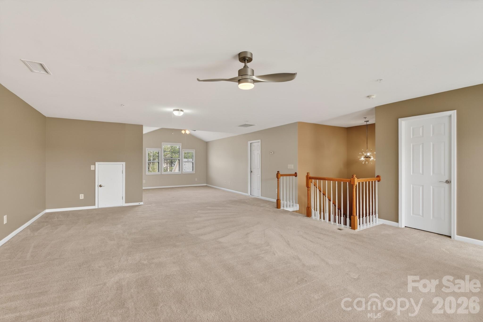 114 Inlet Point Drive Tega Cay, SC 29708 - Photo 31 of 40 a view of an empty room with chandelier fan and window