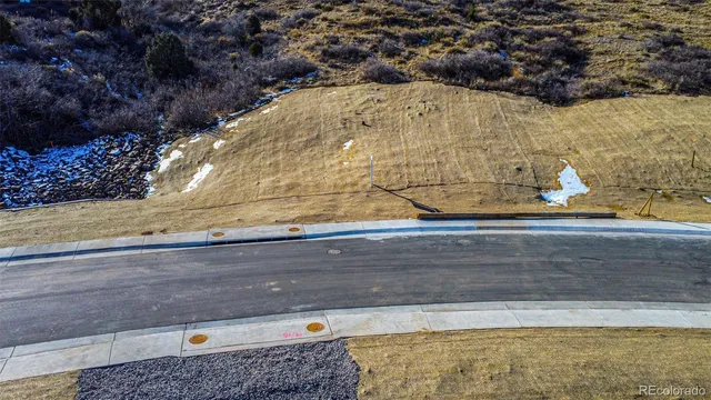 an aerial view of a houses with a yard