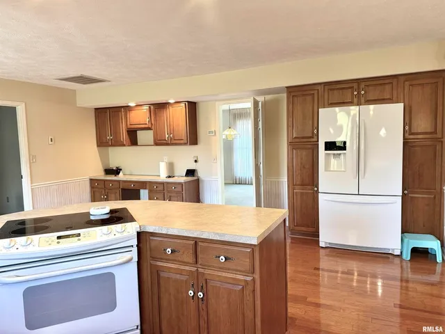 a kitchen with a sink stove and refrigerator