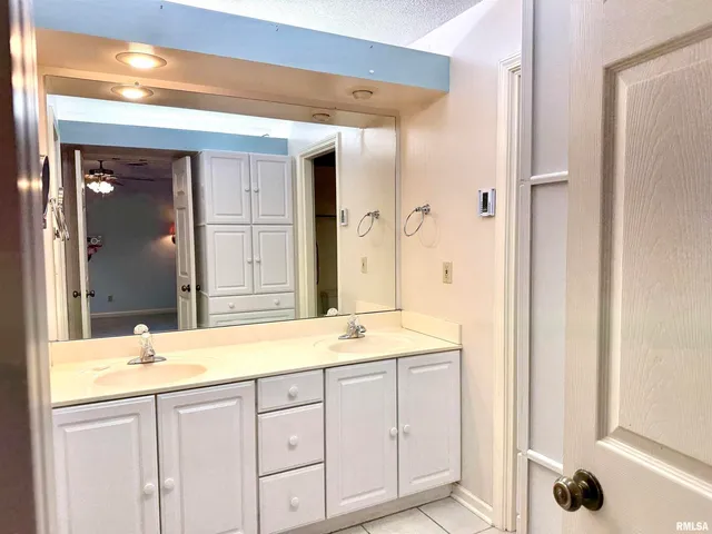 a bathroom with a granite countertop sink mirror and