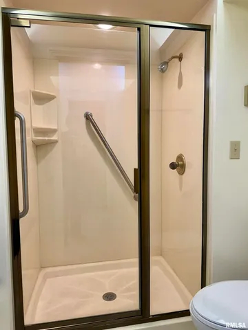 a bathroom with a glass shower door