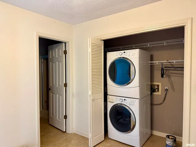 a view of a hallway with washer and dryer