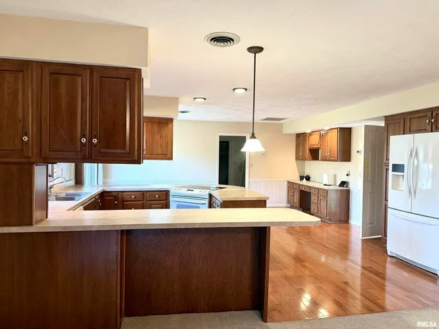 a kitchen with a sink a stove and cabinets