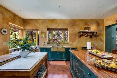 a kitchen with a table and chairs in it