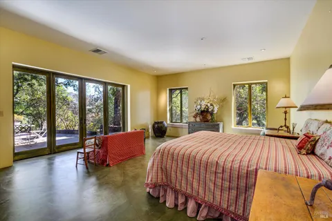 a bedroom with a bed and glass walk in closet