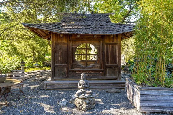 a backyard of a house with a yard and fountain