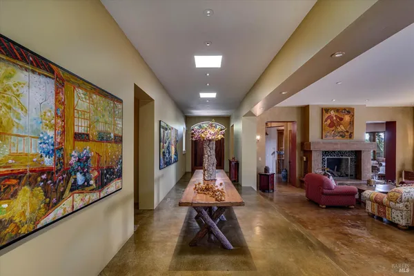 a living room with furniture large window and flat screen tv