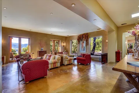a living room with furniture large window and flat screen tv