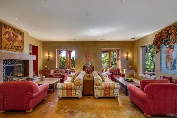 a living room with furniture fireplace and a large window