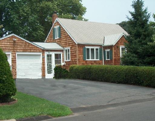 52 Northfield Road Fairfield, CT 06824 - Photo 1 of 1 a front view of a house with a yard and garage