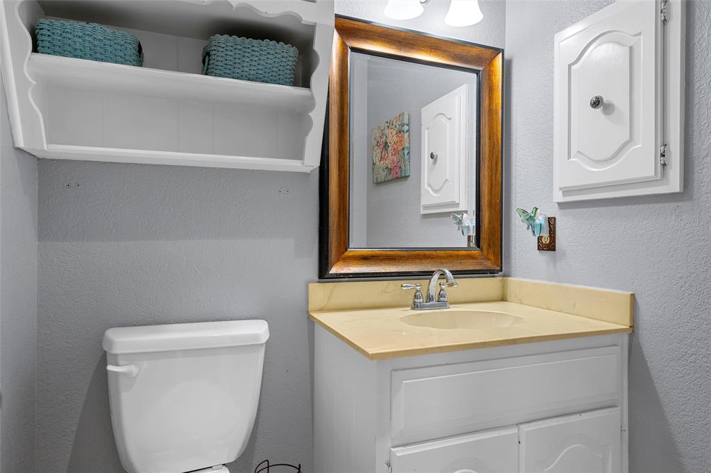 1038 South Old Robinson Road Robinson, TX 76706 - Photo 19 of 36 Bathroom featuring a textured wall and vanity
