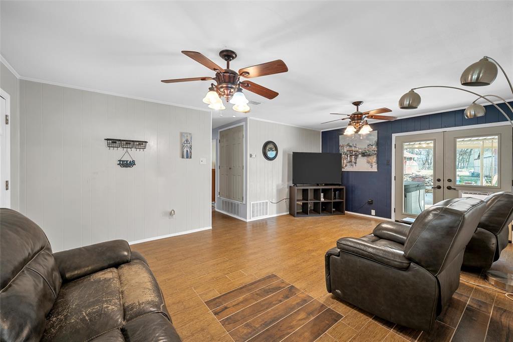 1038 South Old Robinson Road Robinson, TX 76706 - Photo 5 of 36 Living area with wood finish floors, french doors, crown molding, ceiling fan, and wooden walls