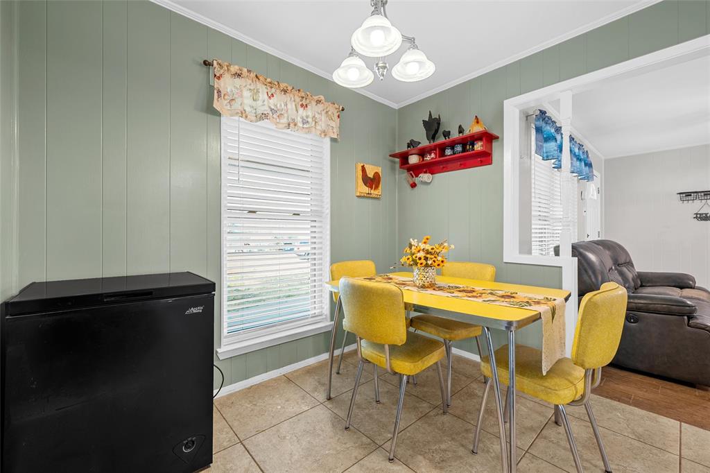 1038 South Old Robinson Road Robinson, TX 76706 - Photo 7 of 36 Dining room featuring suspended lighting, plenty of natural light, and crown molding