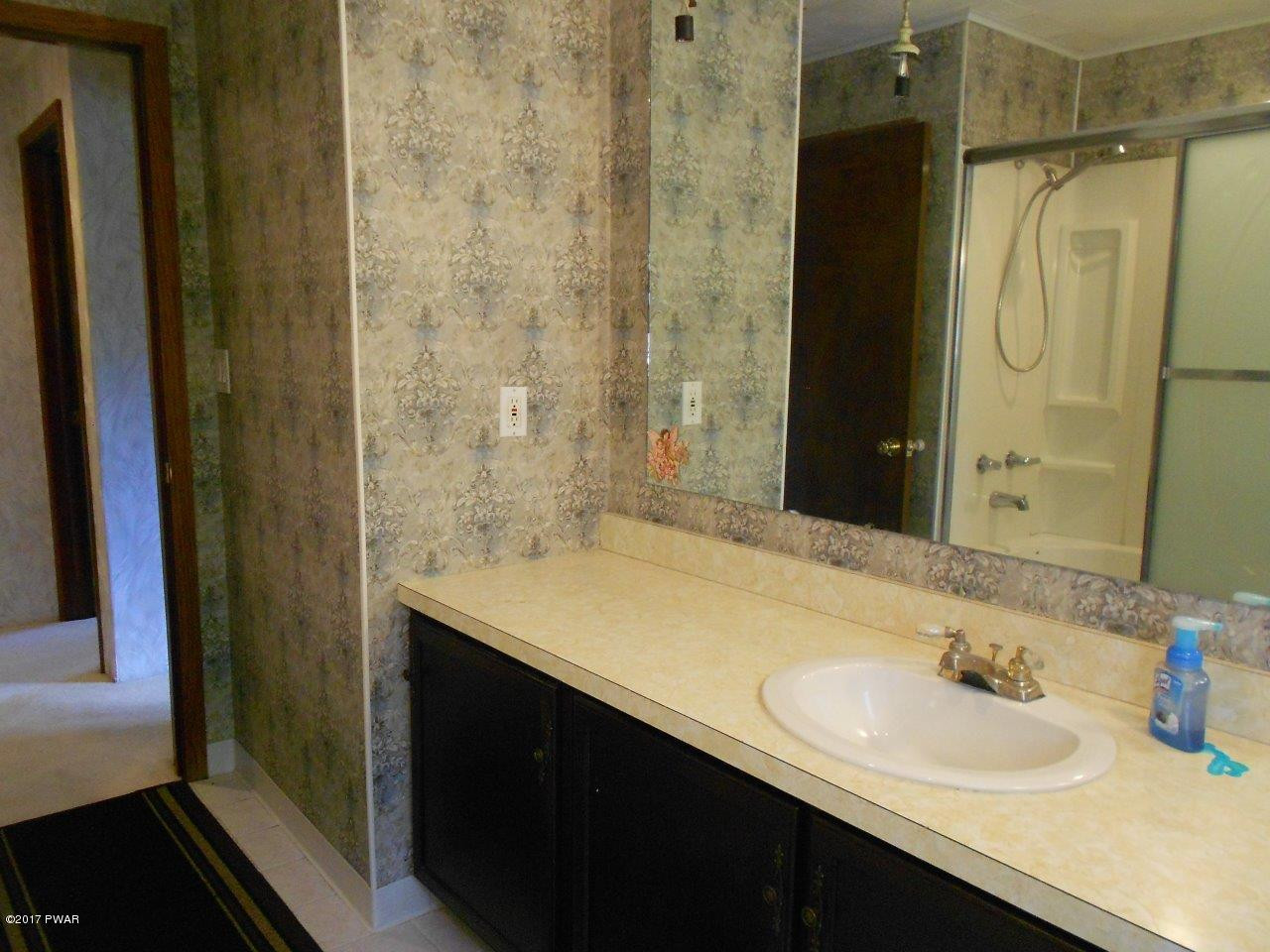 369 Roemerville Road Greentown, PA 18426 - Photo 31 of 45 a bathroom with a sink and a mirror