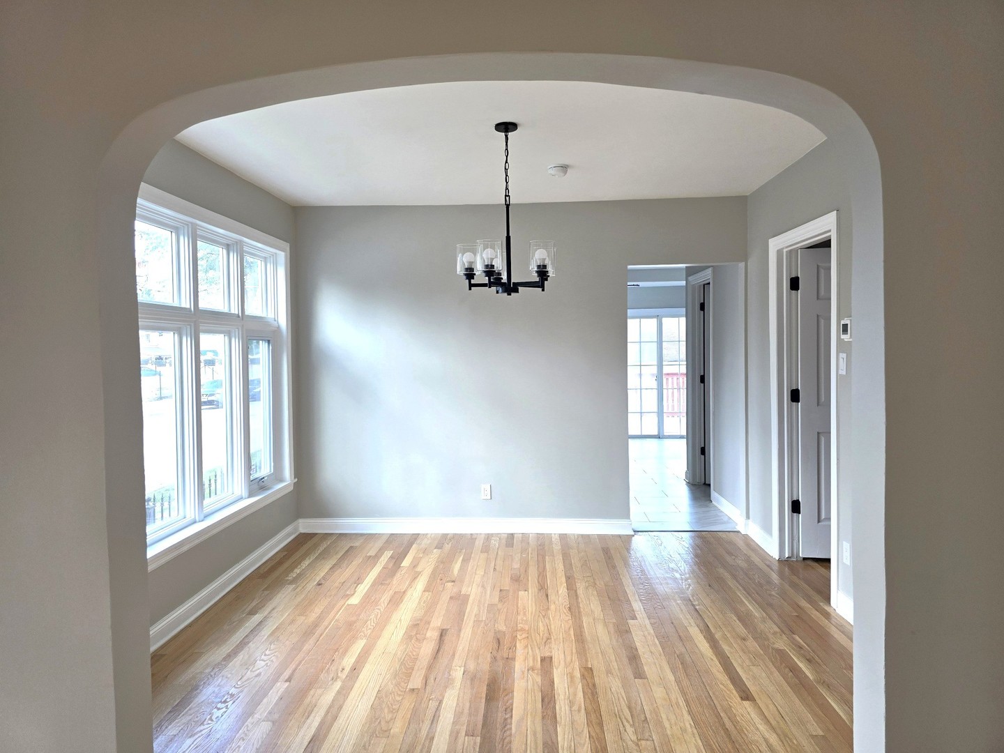5657 North Parkside Avenue Chicago, IL 60646 - Photo 13 of 29 a view of a room with wooden floor chandelier and windows
