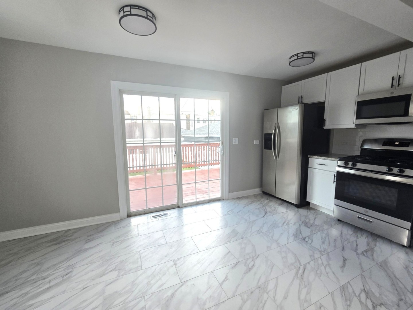 5657 North Parkside Avenue Chicago, IL 60646 - Photo 15 of 29 a view of a kitchen with a stove cabinets and a wooden floor