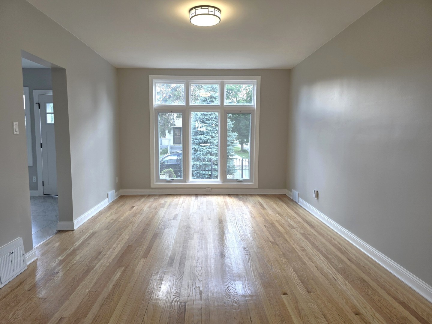 5657 North Parkside Avenue Chicago, IL 60646 - Photo 16 of 29 wooden floor in an empty room with a window