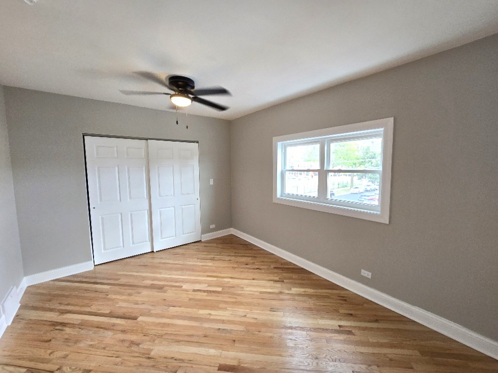 5657 North Parkside Avenue Chicago, IL 60646 - Photo 20 of 29 a view of empty room with wooden floor and fan