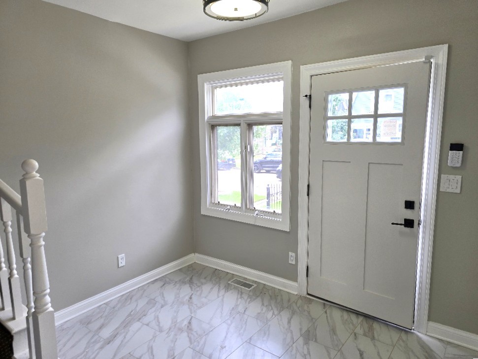 5657 North Parkside Avenue Chicago, IL 60646 - Photo 22 of 29 an empty room with wooden floor and windows