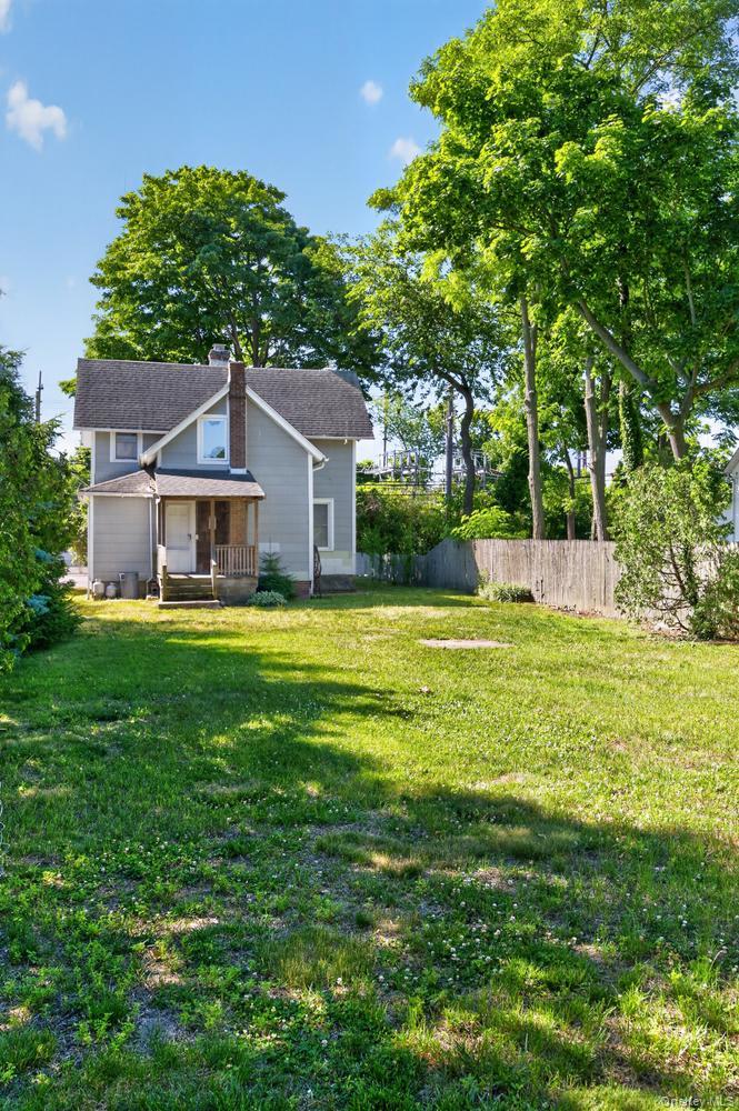 49 Cedar Street Babylon, NY 11702 - Photo 18 of 20 a view of a house with a big yard and large tree