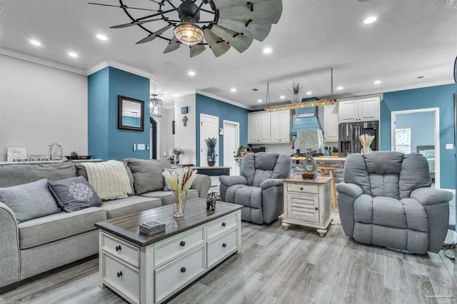 a living room with furniture and a chandelier