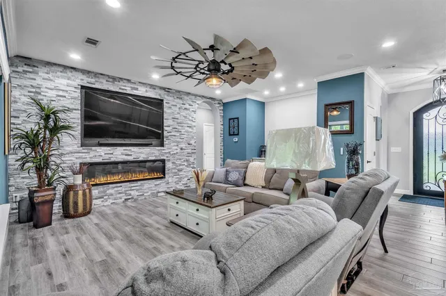a living room with fireplace furniture and a flat screen tv