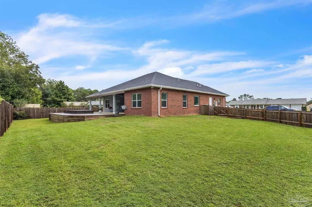 a front view of house with yard and outdoor seating