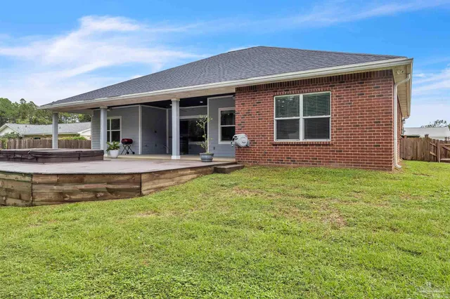 a view of house with a back yard