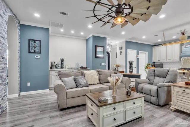a living room with furniture and a chandelier